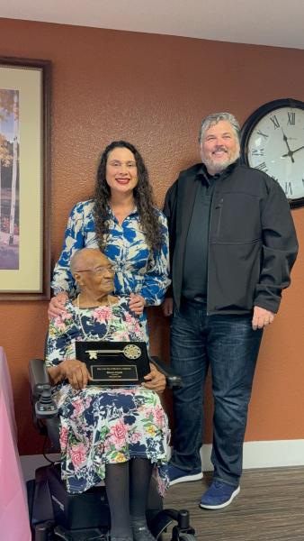 Elnora receiving the award