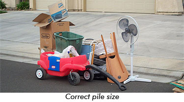 a neat pile of junk on the street showing the correct size allowed